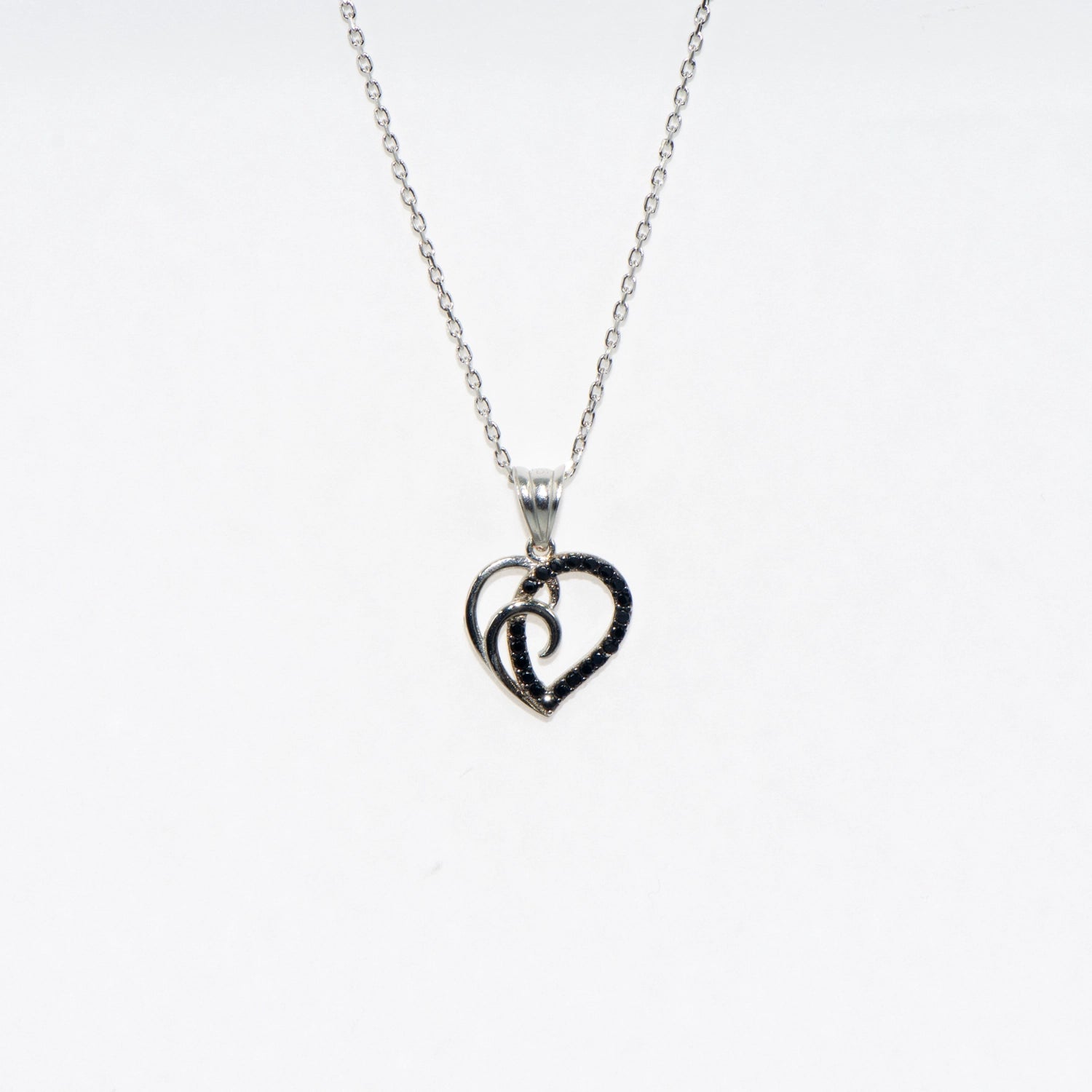 Elegante 925 Silber Halskette mit Herz Anhänger. Verziert mit schwarzen Zirkonia-Steinen und rhodinierter Oberfläche.