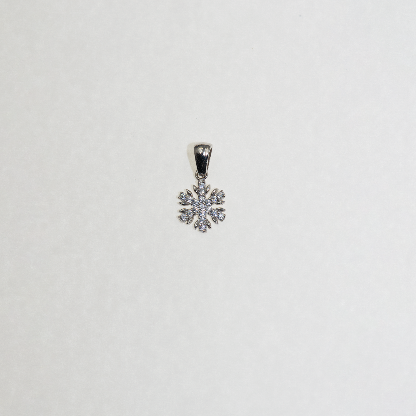 Kleiner Schneeflocke Anhänger aus Silber 925 mit funkelnden Zirkonia-Steinen und feinem winterlichem Design.